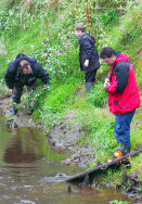 Dr Drew examines the bank under the watchful eye of James