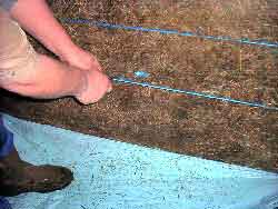 Cutting the binding of the bale