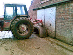 Tractor holds parlour door closed